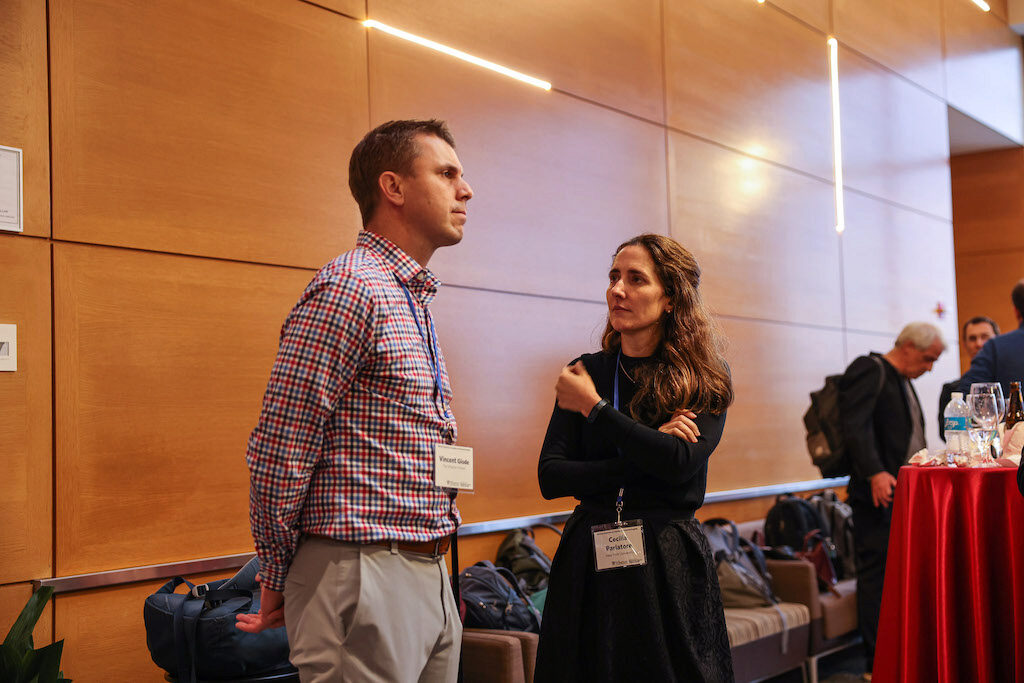 Two conference attendees chatting at a reception