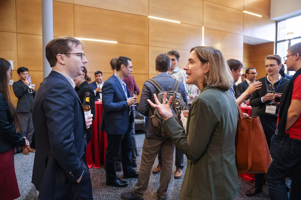 Conference attendees chat during a reception