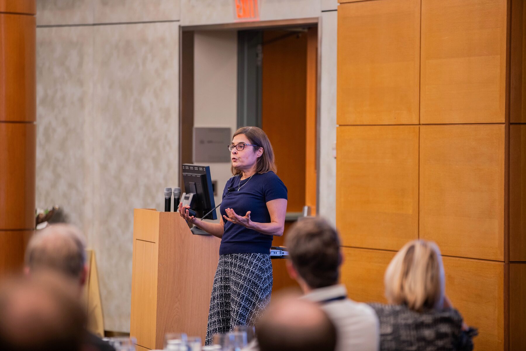 A speaker addresses an audience in an academic setting